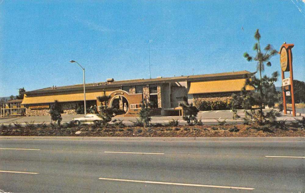 A very retro building in mustard yellow without the usual exotic trappings of an American Chinese restaurant, though notably a big circular gate.