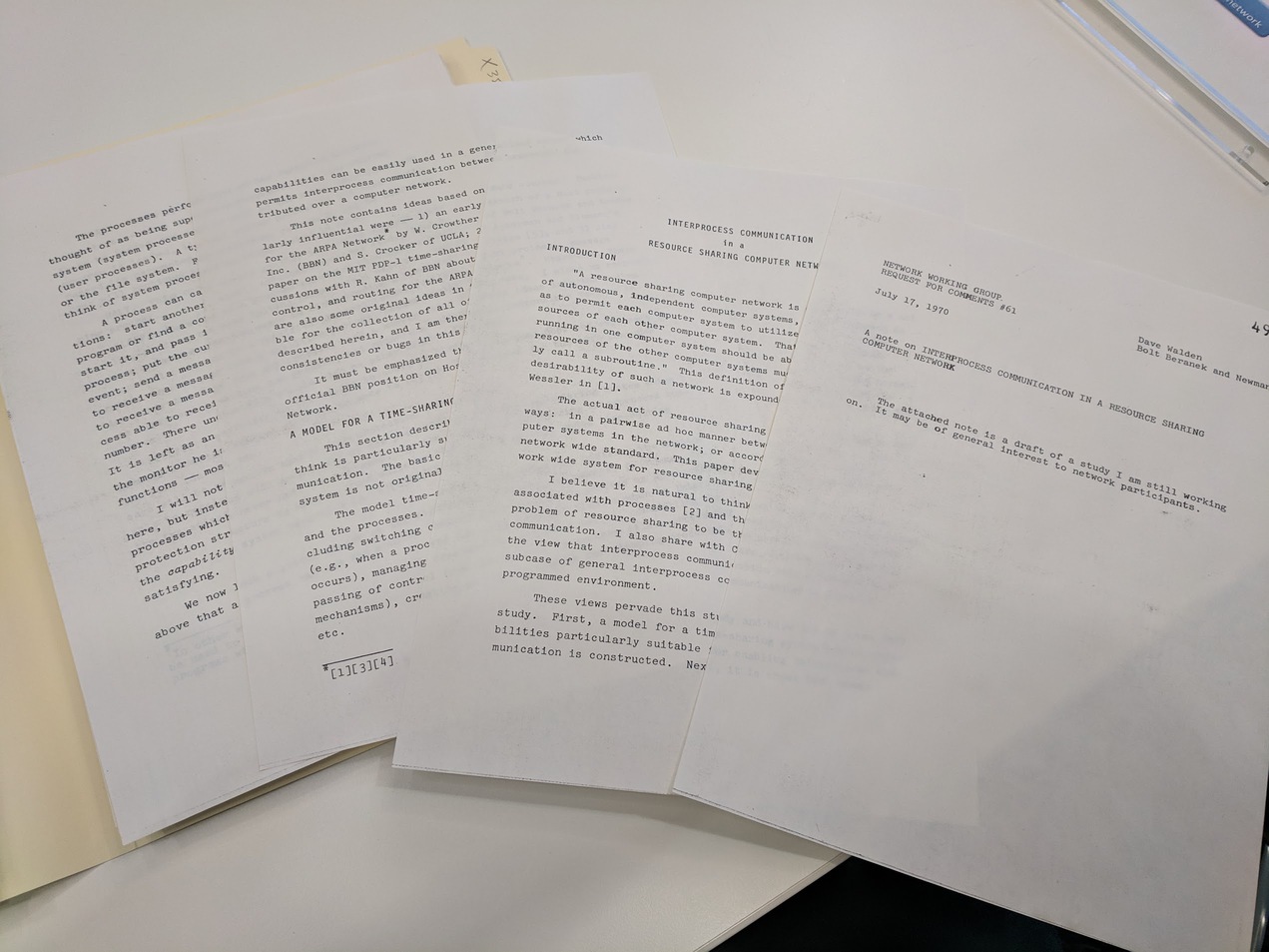 Four handsomely typewritten pages fanned out on a desk.